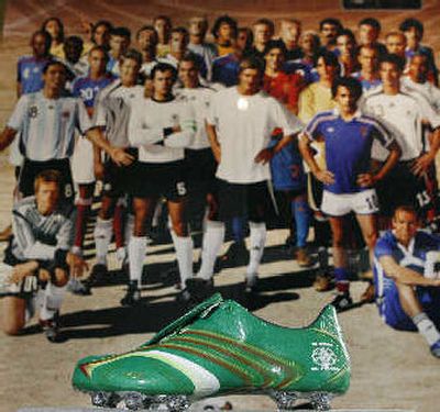 
The Adidas' World Cup advertisement poster is shown in a display with the Mexican Nationals team football boot at Adidas' North American headquarters.  
 (Associated Press / The Spokesman-Review)