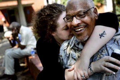 
Kenneth Foster Sr.,  father of death row inmate Kenneth Foster, and Tasha Foster, the inmate's wife, hug Thursday. Associated Press
 (Associated Press / The Spokesman-Review)