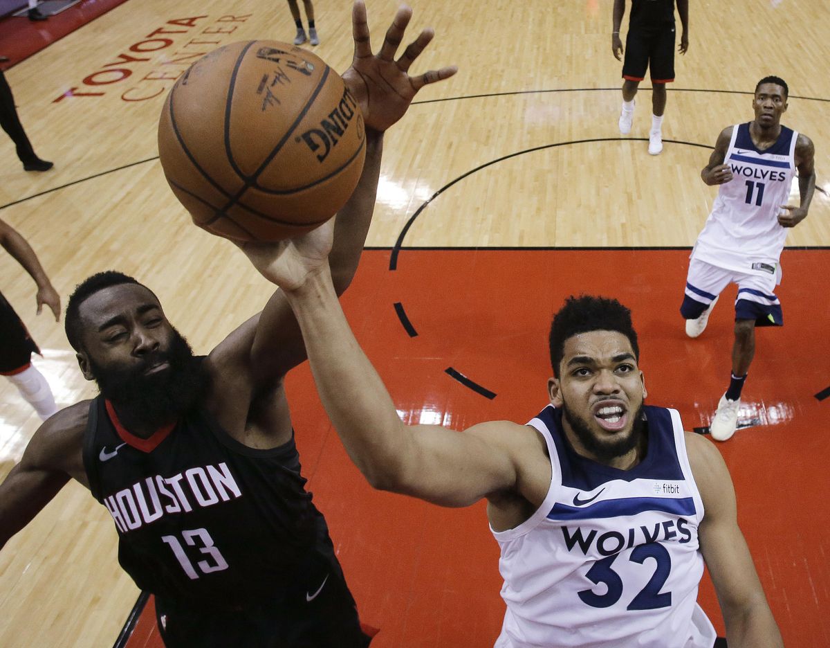 Houston Rockets guard James Harden (13) blocks the shot of Minnesota Timberwolves center Karl-Anthony Towns (32) during the second half in Game 5 of a first-round NBA basketball playoff series Wednesday, April 25, 2018, in Houston. (Eric Christian Smith / Associated Press)