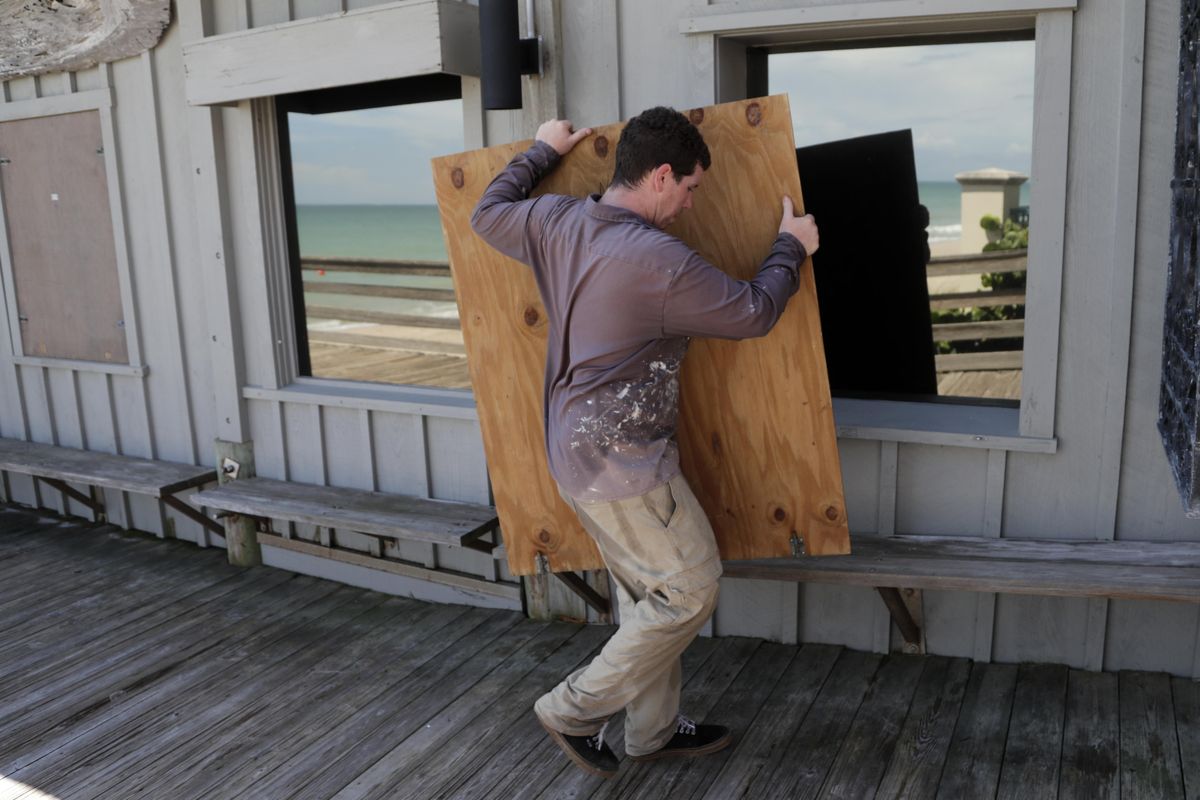 Lyle Fidgeon boards windows at the Ocean Grill in preparation for Hurricane Dorian, Friday, Aug. 30, 2019, in Vero Beach, Fla. The National Hurricane Center says Dorian could hit the Florida coast as a major hurricane. (Lynne Sladky / Associated Press)