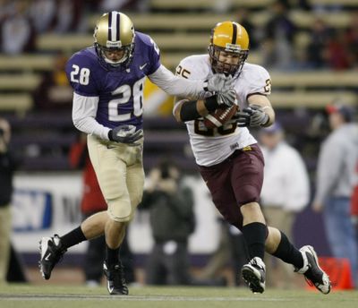 Associated Press Few fans were on hand Saturday (note empty seats in background) to watch the Huskies’ latest loss. Here, Arizona State’s Mike Nixon intercepts a pass intended for Tony Chidiac. (Associated Press / The Spokesman-Review)