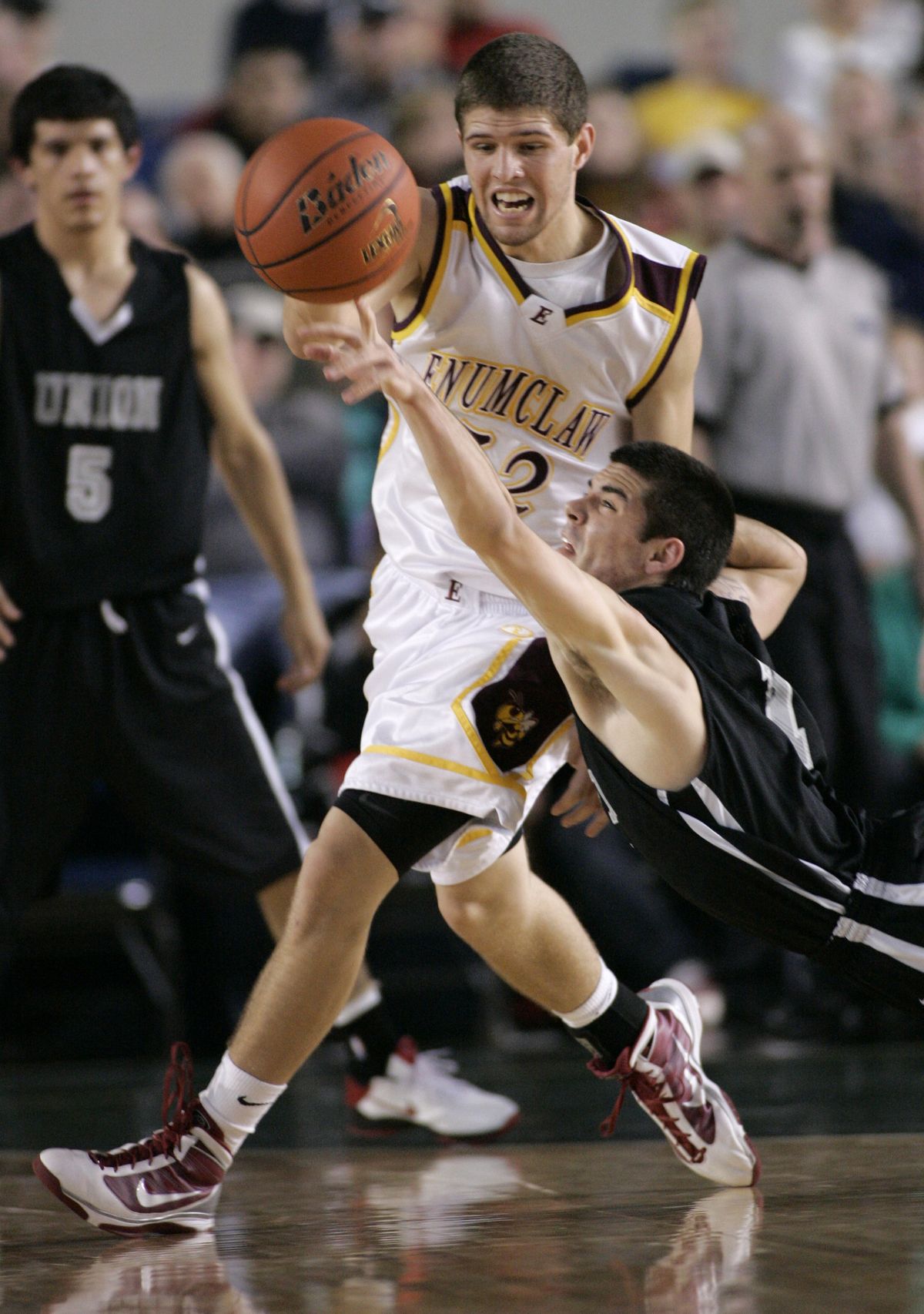 Enumclaw’s Riley Carel grabs the ball while Union’s Chris Morgan comes up short.  (Associated Press)