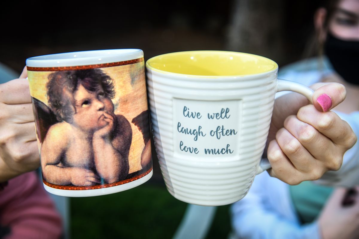 West Valley High School student Kennedie Krieger, left, and Lauren Carson display their mugs given to them by teacher Jodee Cahalan. (Dan Pelle/THE SPOKESMAN-REVIEW)