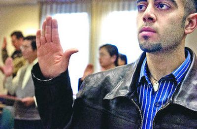 
Ali Albakriy, 24, an Iraqi refugee,  was naturalized as a U.S. citizen on Tuesday in Spokane by U.S.  Magistrate Cynthia Imbrogno. 
 (Jed Conklin / The Spokesman-Review)