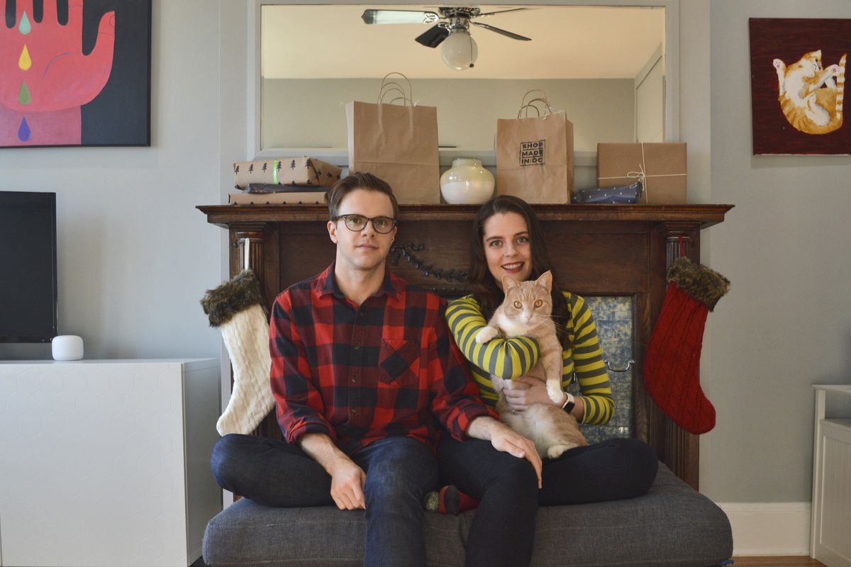 In this photo provided by Kate Hilts, Ross Hettervig, left, and Kate Hilts pose for a photo with their cat, Potato, on Nov. 14, 2020, in Washington. Veterinarians and owners report some pets are being medicated for anxiety, and others are being put on diets because of too many treats and not enough exercise in parks that humans may be avoiding because of virus concerns. Hilts says her cat, a rescue who joined their household in March 2019, always seemed to enjoy attention from strangers but now hides from visitors.  (Kate Hilts)