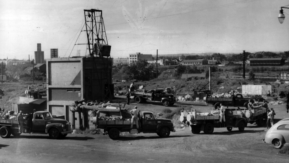 1948: The city of Spokane mandated universal garbage pickup for every home in Spokane. Flatbed garbage trucks line up at one of three city trash crematories in the area that is now the University District. Trash burning was discontinued in the early 1960s, partly because people resisted separating their burnables, and aerosol cans often exploded in the incinerators. Also, replacing the aging smokestacks on the incinerators was very costly. Trash disposal switched to the Five Mile landfill, among other locations. Modern trash compactor trucks were added in the 1960s.  (WASHINGTON STATE ARCHIVES - DIGITAL ARCHIVES)