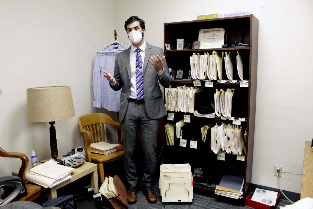 Public defender Drew Flood, with the nonprofit law firm Metropolitan Public Defender, looks his files for the criminal cases he is currently working on May 5 on in Portland.  (Gillian Flaccus)