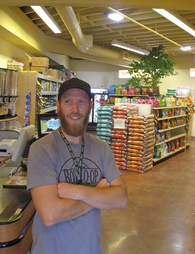 Boise Co-op pet food buyer Zach Jones stands in the Boise store’s new space dedicated to natural pet food and supplies. (Associated Press)