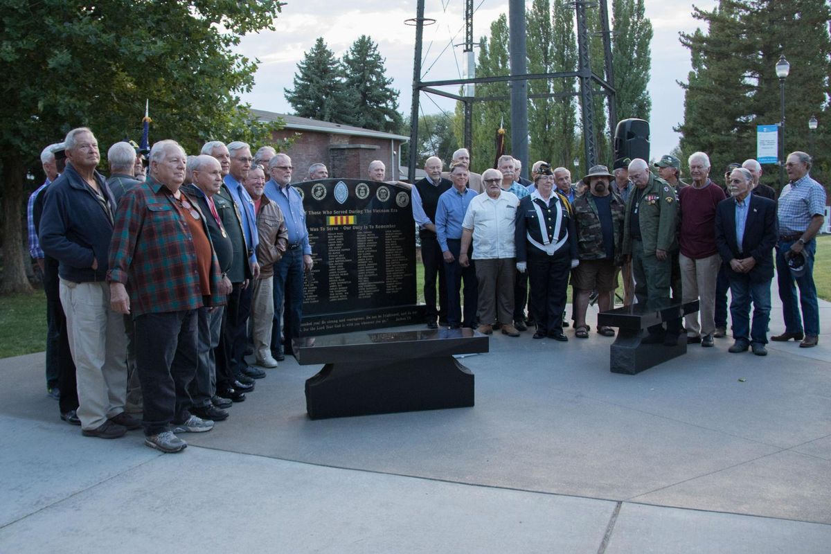 Nearly 40 veterans from Upper Columbia Academy stayed long enough to pose for a photo at the dedication of the monument Sept. 29, 2017. Gail Jones Branum, in Air Force uniform, stands to the right of the monument. Carl Garber stands in camouflage to her left. To Garber’ left, with head bowed and medals displayed, is Dick Scheib. Dave Fisher is hidden behind the monument. (Upper Columbia Academy Alumni / Upper Columbia Academy Alumni)