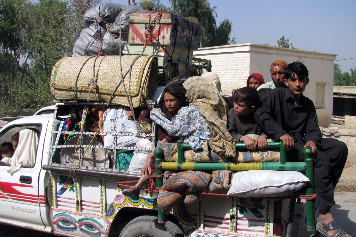 A Pakistani tribal family who fled South Waziristan  passes through a checkpoint Monday on the outskirts of Bannu, a town on the edge of  Waziristan. As many as 150,000 civilians – possibly more – have left South Waziristan in recent months, with several thousand over the last few days alone. Associated Press photos (Associated Press photos / The Spokesman-Review)
