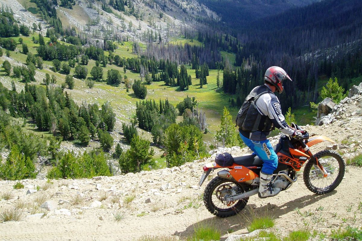 A dirt biker rides a trail above Miners Basin in the Chelan Ranger District of the Okanogan National Forest.  (Mason Schuur)