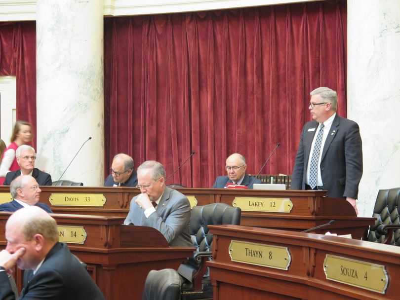 Sen. Todd Lakey, R-Nampa, presents the House-amended unemployment insurance tax cut bill to a skeptical Idaho Senate on Wednesday. Lakey said the House amendments weren’t a full “radiator capping,” replacing the entire vehicle of the bill and leaving only the bill number. Instead, he said, “I think they noticed the trailer hitch on the back of this bill and attached a travel-trailer to it. So I think this bill has been travel-trailered.” The Senate killed the bill, 5-29. (Betsy Z. Russell)