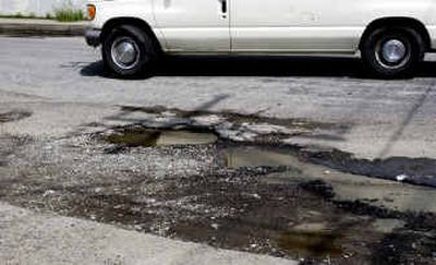 Potholes on Whipple Road near Sprague Avenue await patching. According to Spokane County's road maintenance records, the city spent $63,000 on pothole patching, versus $155,000 budgeted. The city had budgeted $4.1 million for probation services, street maintenance, engineering and the six other actual-usage contracts, but only spent about $2 million.Potholes on Whipple Road near Sprague Avenue await patching. According to Spokane County's road maintenance records, the city spent $63,000 on pothole patching, versus $155,000 budgeted. The city had budgeted $4.1 million for probation services, street maintenance, engineering and the six other actual-usage contracts, but only spent about $2 million.
 (Steve Thompson/Spokesman ReviewSteve Thompson/Spokesman Review / The Spokesman-Review)