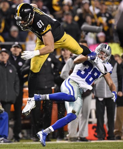 Pittsburgh Steelers tight end Jesse James (81) is upended as he attempts to leap over Dallas Cowboys strong safety Jeff Heath in Pittsburgh on Sunday. (Don Wright / Associated Press)