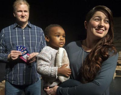 Doug Beschta, of Spokane Children’s Theatre, left, has four tickets in his hand to Disneyland, donated by Disney and Delta Airlines, to give to SCT raffle winner Carolina Wilson and her daughter Kalila on Jan. 28. (Dan Pelle/Spokesman-Review)