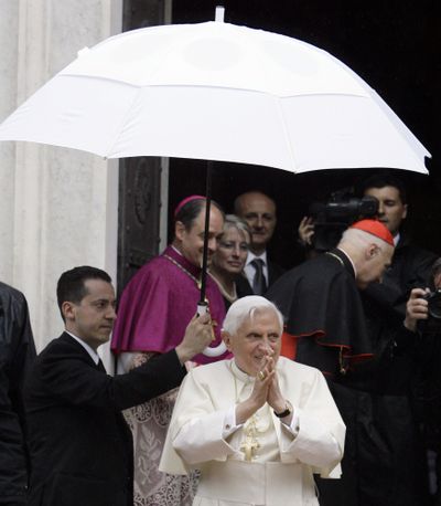 Pope Benedict XVI’s butler, Paolo Gabriele, at left holding the umbrella in this May 2008 photo, has been arrested in an embarrassing leaks scandal. (Associated Press)