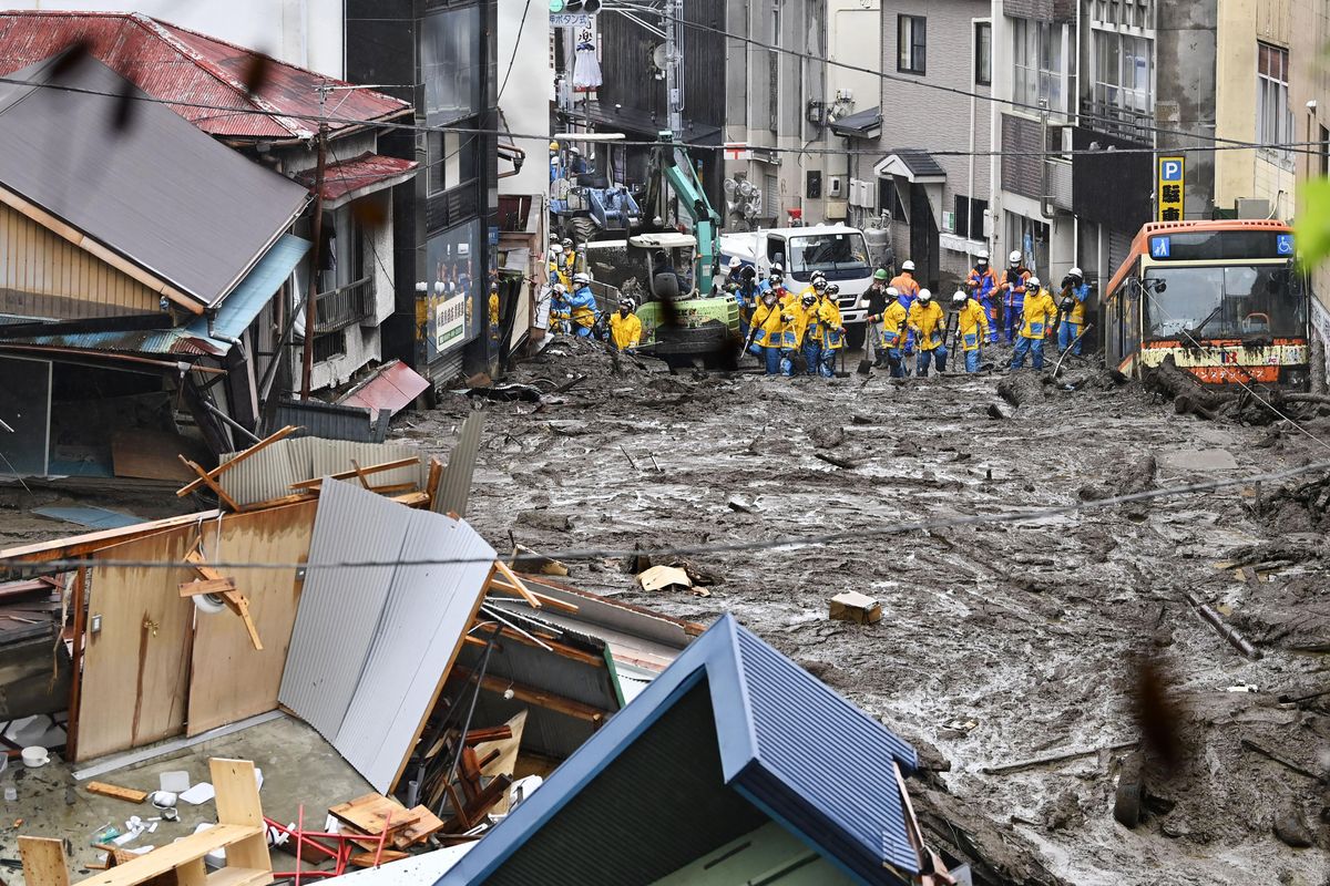 Rescuers conduct a search operation at the site of a mudslide at Izusan in Atami, Shizuoka prefecture, southwest of Tokyo, Sunday, July 4, 2021. More than 1,000 soldiers, firefighters and police on Sunday waded through a giant mudslide that ripped through the resort town as it swept away houses and cars.  (SUB)