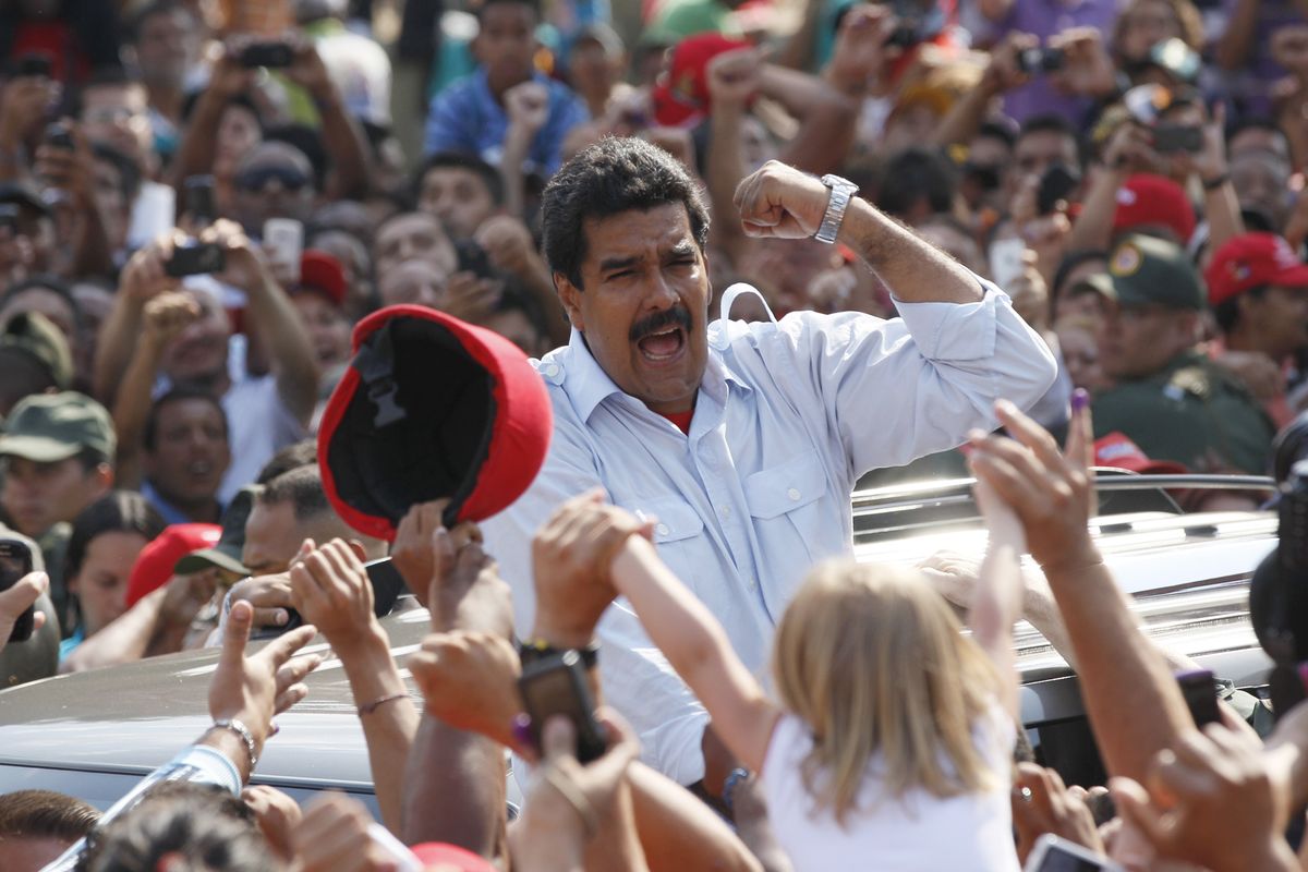 Venezuela’s interim President Nicolas Maduro gestures as he leaves a polling station after voting in the presidential election in Caracas on Sunday. (Associated Press)