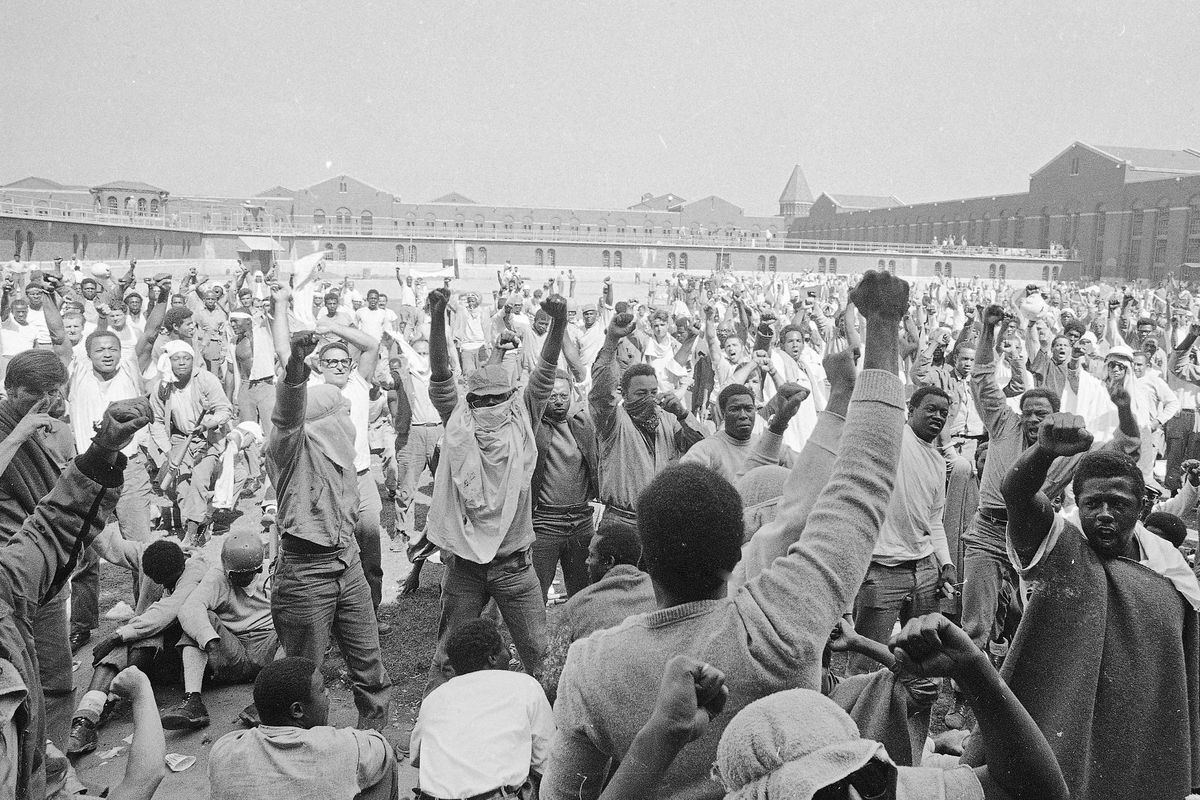 In this Sept. 1971 photo, Inmates at the Attica Correctional Facility, in Attica, NY, raise their hands in clenched fists in a show of unity during the Attica uprising, which took the lives of 43 people. Fifty years after the Attica prison uprising, the families of slain and injured prison guards say they