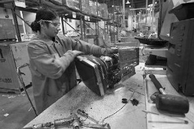 
Raj Winder-Kaur dismantles and sorts computer and electronic components to be processed at the Hewlett-Packard recycling facility in Roseville, Calif., on Tuesday. 
 (Associated Press / The Spokesman-Review)