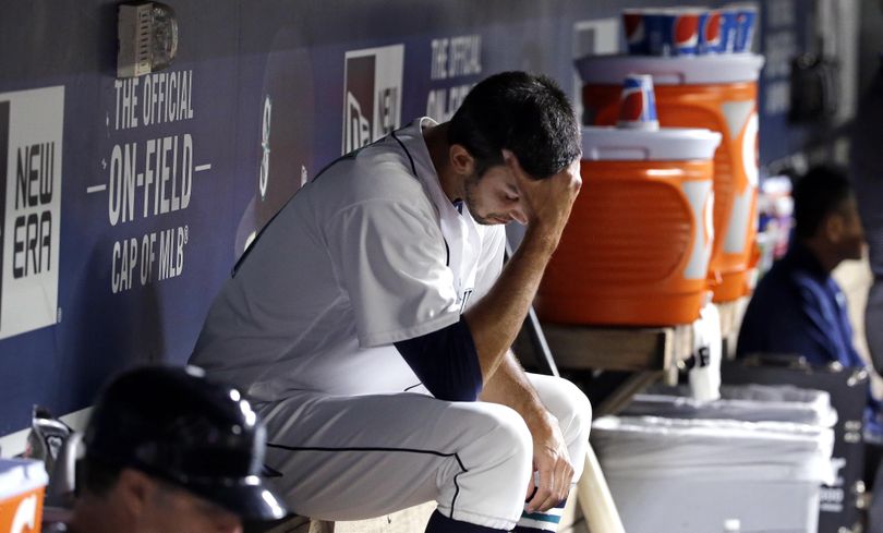 Seattle Mariners relief pitcher Steve Cishek looks down as he sits in the dugout after giving up a home run and being relieved in the ninth inning against the Boston Red Sox Monday, Aug. 1, 2016, in Seattle. (Elaine Thompson / Associated Press)