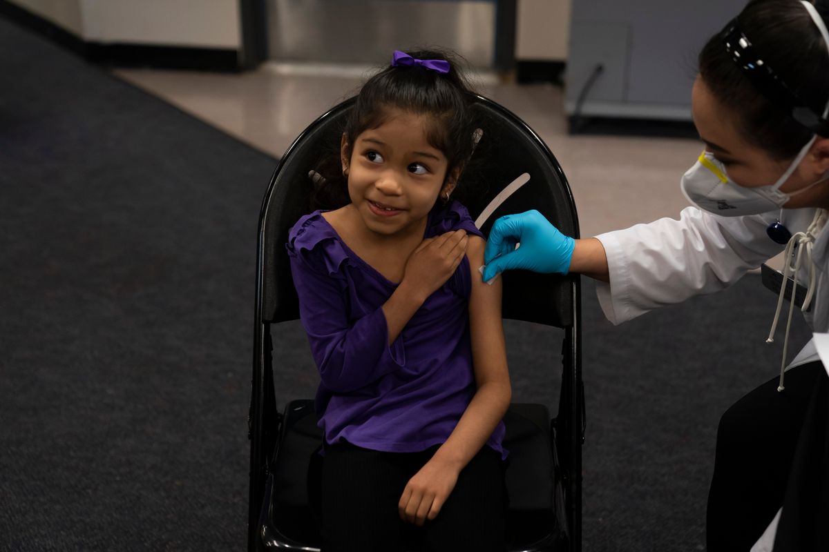 FILE - Elsa Estrada, 6, smiles at her mother as pharmacist Sylvia Uong applies an alcohol swab to her arm before administering the Pfizer COVID-19 vaccine at a pediatric vaccine clinic for children ages 5 to 11 set up at Willard Intermediate School in Santa Ana, Calif., Nov. 9, 2021. As of Tuesday, Jan. 11, 2022, just over 17% of children in the U.S. ages 5 to 11 were fully vaccinated, more than two months after shots for them became available.  (Jae C. Hong)