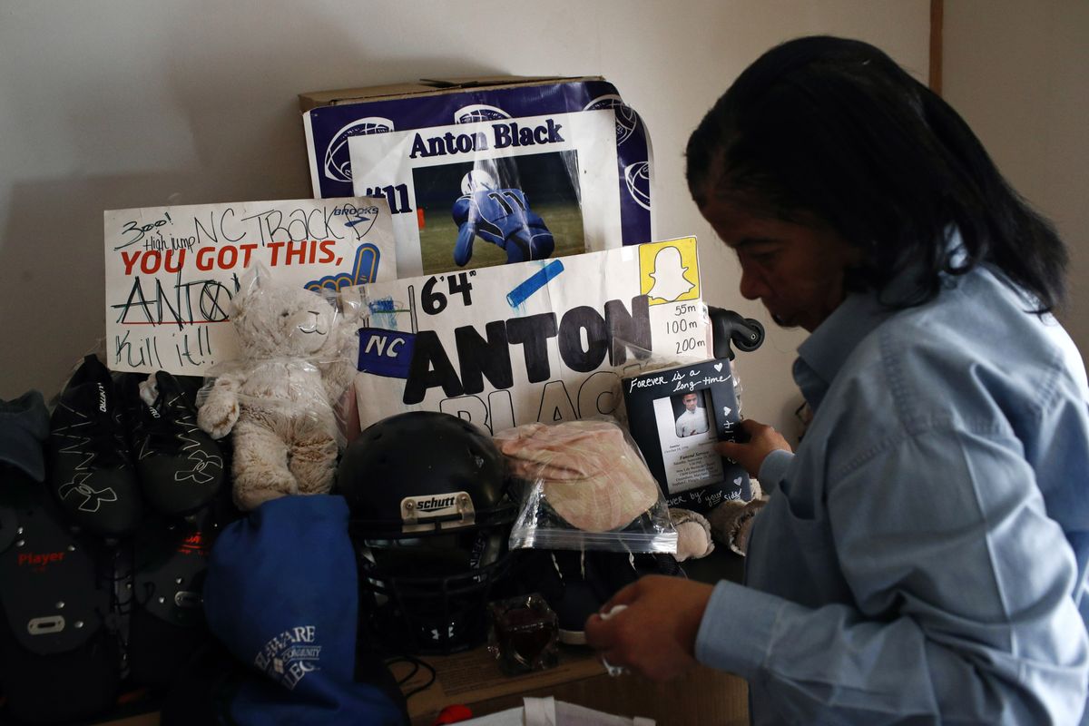 FILE - In this Jan. 28, 2019 file photo, Jennell Black, mother of Anton Black, looks at a collection of her son