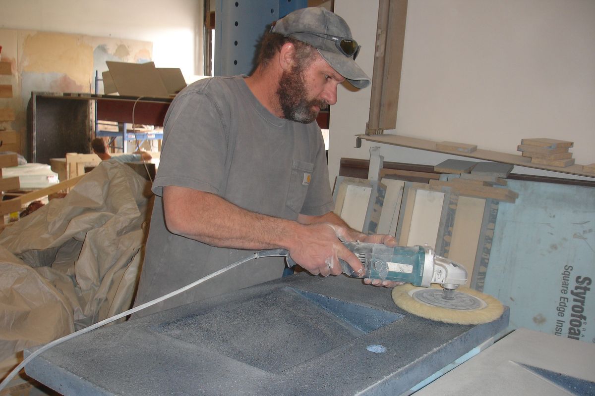 Jon Cross works on a sink made from recycled glass.  (Jean Arthur / Down to EarthNW Correspondent)