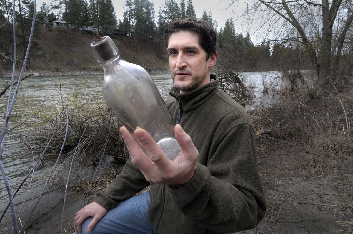 Darin Winkler holds a bottle containing a note written on March 30, 1913, that he found last weekend in the Spokane River. It had been dropped into a creek outside Rockford, Wash., by Emmett Presnell.  (Photos by CHRISTOPHER ANDERSON / The Spokesman-Review)