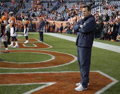 Coach Gary Kubiak stands on the field prior to his final game as the Denver Broncos head coach on Sunday. (Jack Dempsey / Associated Press)