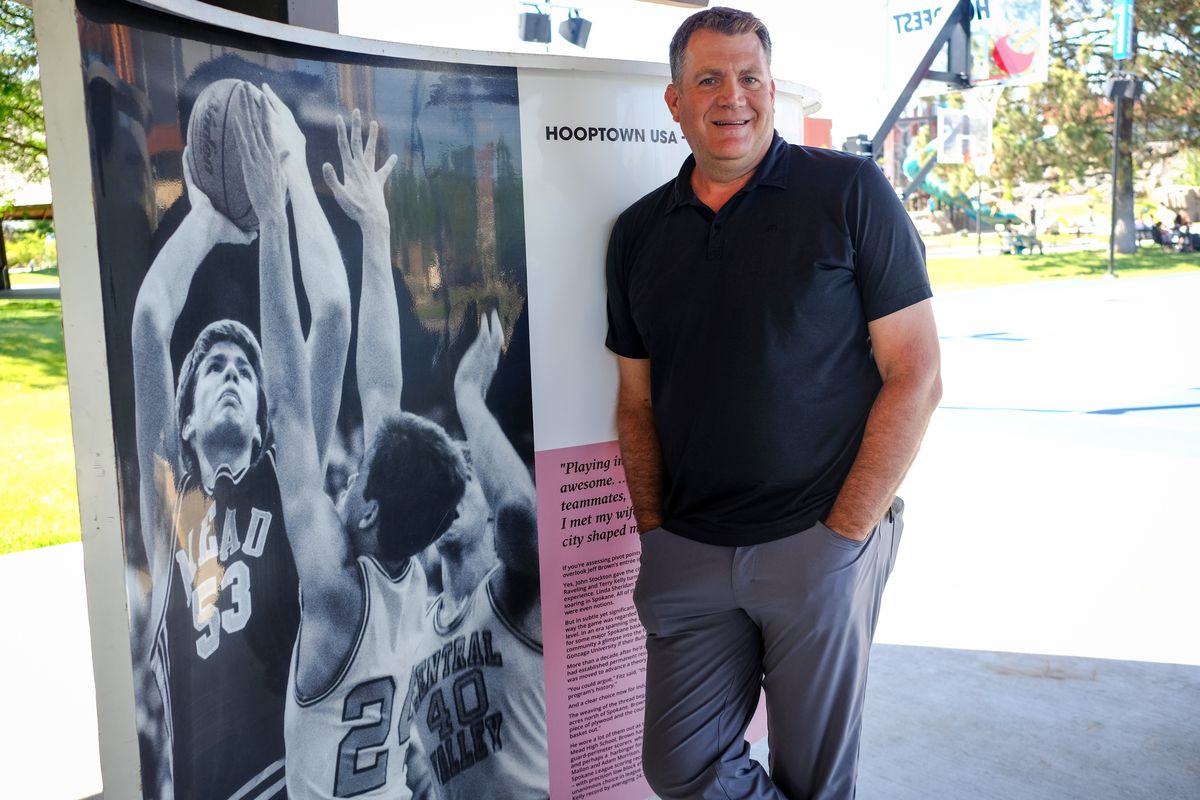 Gonzaga and Mead High School basketball legend Jeff Brown poses for a photo with his Hooptown Hall of Fame board on Thursday at Riverfront Park.  (Tyler Tjomsland/The Spokesman-Review)
