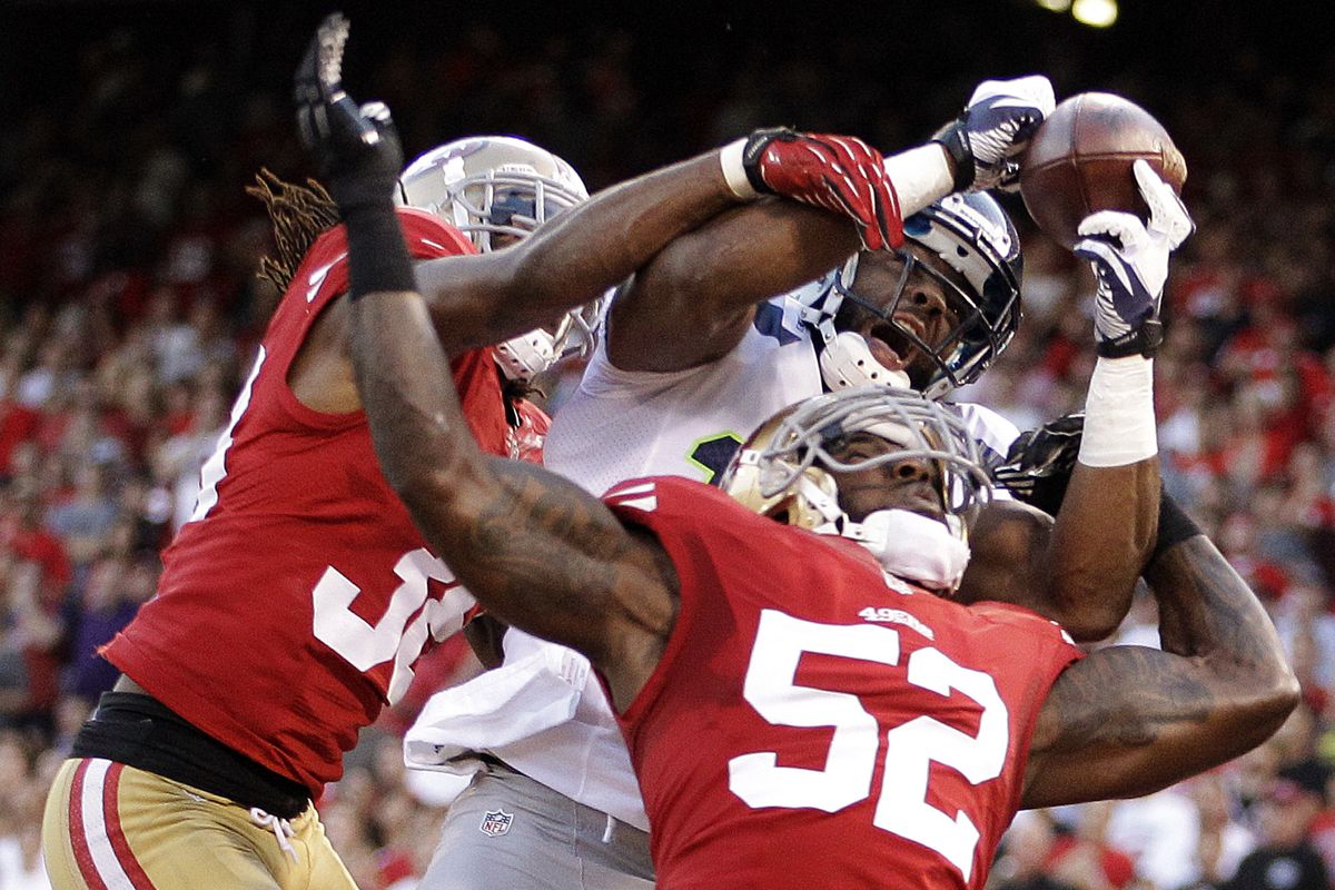 49ers linebacker Patrick Willis, front, and safety Dashon Goldson break up a pass intended for Seahawks WR Braylon Edwards. (Associated Press)