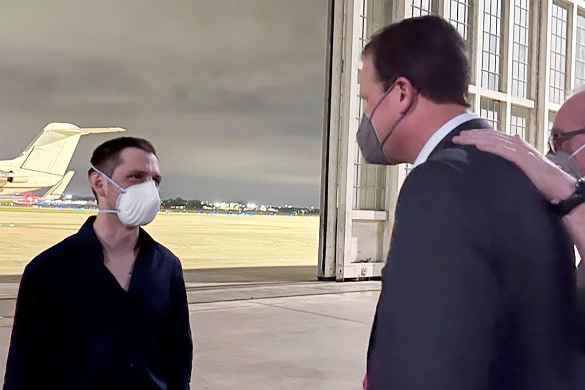 Trevor Reed, left, a Texas resident arrested in Russia in 2019, is greeted by Rep. August Pfluger, R-Texas, at a military airfield in Texas, Thursday, April 28, 2022.  (Jonathan Franks)