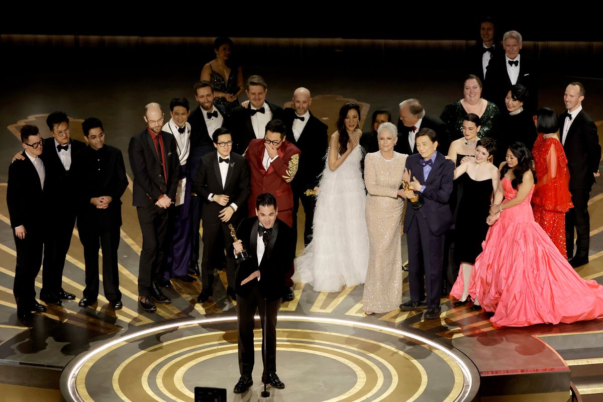 Above: Jonathan Wang accepts the Best Picture award for “Everything Everywhere All at Once” onstage during the 95th Annual Academy Awards at Dolby Theatre on Sunday in Hollywood, Calif. Left: From left, best supporting actor Ke Huy Quan, best actress Michelle Yeoh, best actor Brendan Fraser and best supporting actress Jamie Lee Curtis pose together with awards they won Sunday.  (Kevin Winter)