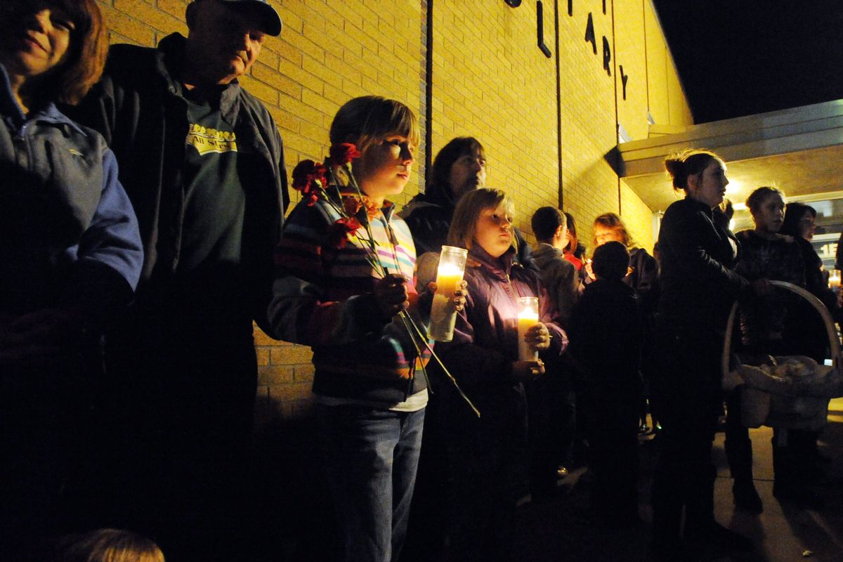 A crowd gathers during a candlelight vigil, Sunday, Nov. 11, 2012, at Southwest Elementary School in Greenwood, Ind., for teacher Jennifer Longworth. Officials did not identify the two people who were killed in a blast on Saturday. However, a candlelight vigil was held for second-grade teacher Jennifer Longworth. She and her husband, John Dion Longworth, lived at a home destroyed in the blast. (Rob Goebel / The Indianapolis Star)