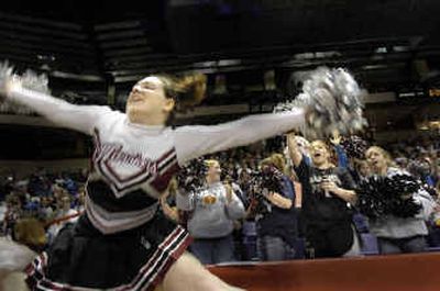 
Almira/Coulee-Hartline cheerleader Jessica West leaps all alone in front of the stands trying to rally her team. She is the only cheerleader for the girls team. 
 (Christopher Anderson/ / The Spokesman-Review)