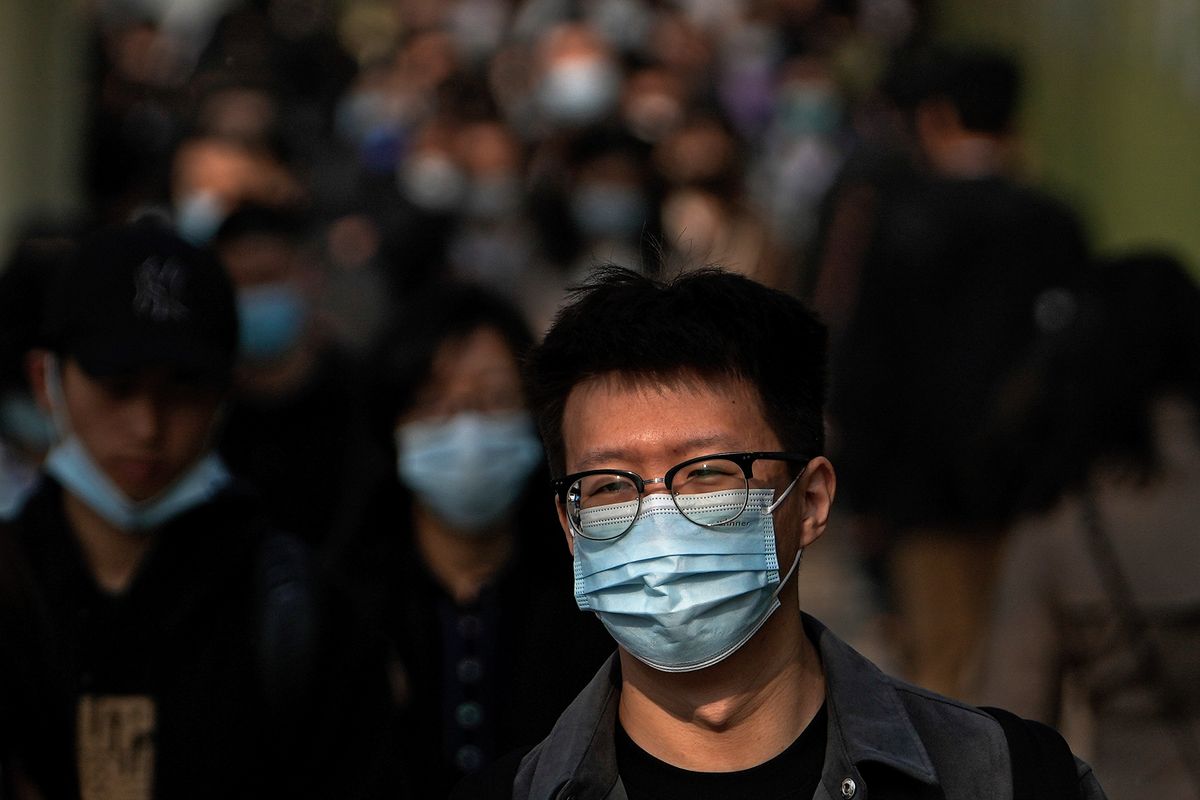 People wearing face masks to help protect from the coronavirus head to work at the Central Business District during the morning rush hour, Monday, April 18, 2022, in Beijing.  (Andy Wong)