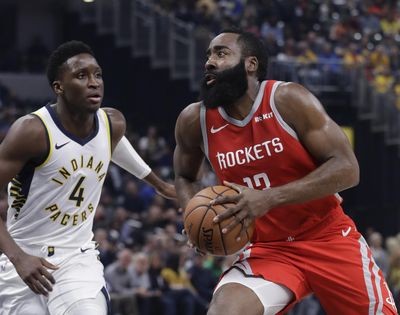 Houston’s James Harden drives to the basket against Indiana’s Victor Oladipo during first-half action on Monday in Indianapolis. (Darron Cummings / AP)