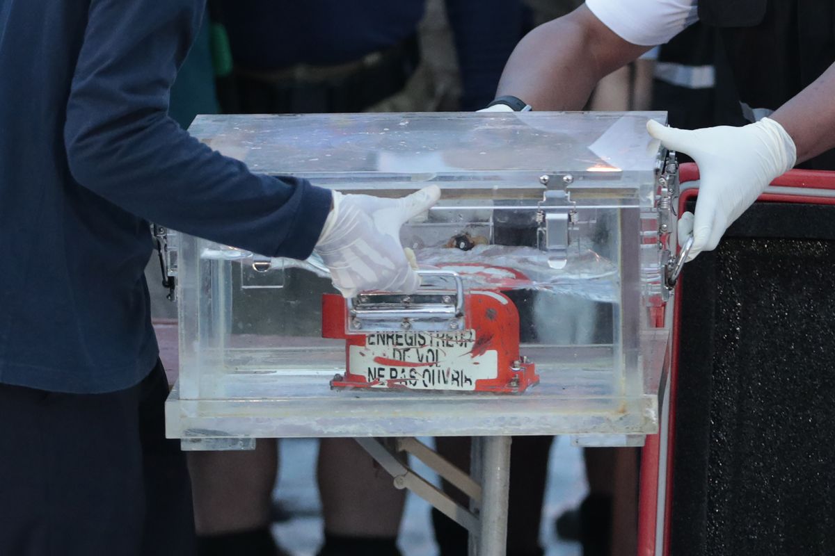Members of the National Transportation Safety Committee carry a box containing the flight data recorder from the Sriwijaya Air flight SJ-182 retrieved from the Java Sea where the passenger jet crashed at the Tanjung Priok Port, Tuesday, Jan. 12, 2021. Indonesian navy divers searching the ocean floor on Tuesday recovered the flight data recorder from a Sriwijaya Air jet that crashed into the Java Sea with 62 people on board, Saturday, Jan. 9, 2021.  (Dita Alangkara)
