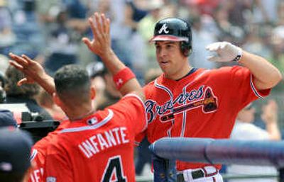 
Atlanta's Mark Teixeira, right, celebrates his third home run on Sunday. Associated Press
 (Associated Press / The Spokesman-Review)