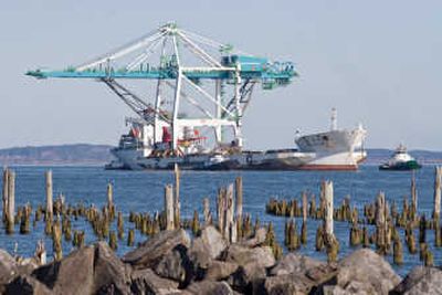 
The Port of Portland's new 185-foot-tall container crane heads upriver near  near Warrenton, Ore., on Wednesday.Associated Press
 (Associated Press / The Spokesman-Review)