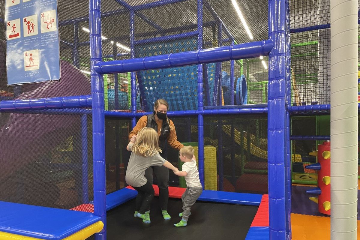 Jamie Dolan jumps with her children, Rory Dolan, left, and Finley Dolan, at We Play in Spokane Valley Mall.  (Nina Culver/The Spokesman-Review)