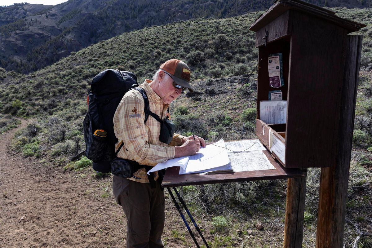Ed Cannady signs the register for the Little Boulder Chain Lakes trail.  (Sarah A. Miller/Idaho Statesman)