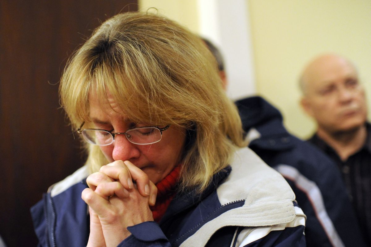 A mourner bows her head inside the St. Rose of Lima Roman Catholic Church at a vigil service for victims of the Sandy Hook Elementary School shooting, in Newtown, Conn. Friday, Dec. 14, 2012. (Andrew Gombert / Pool Epa)
