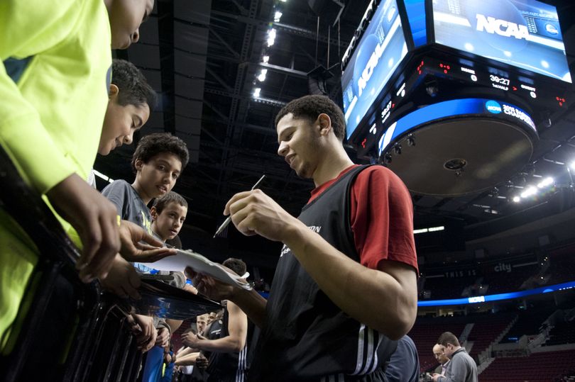 EWU’s Tyler Harvey signs autographs for children after his team’s practice session Wednesday in Portland’s Moda Center. (Dan Pelle)