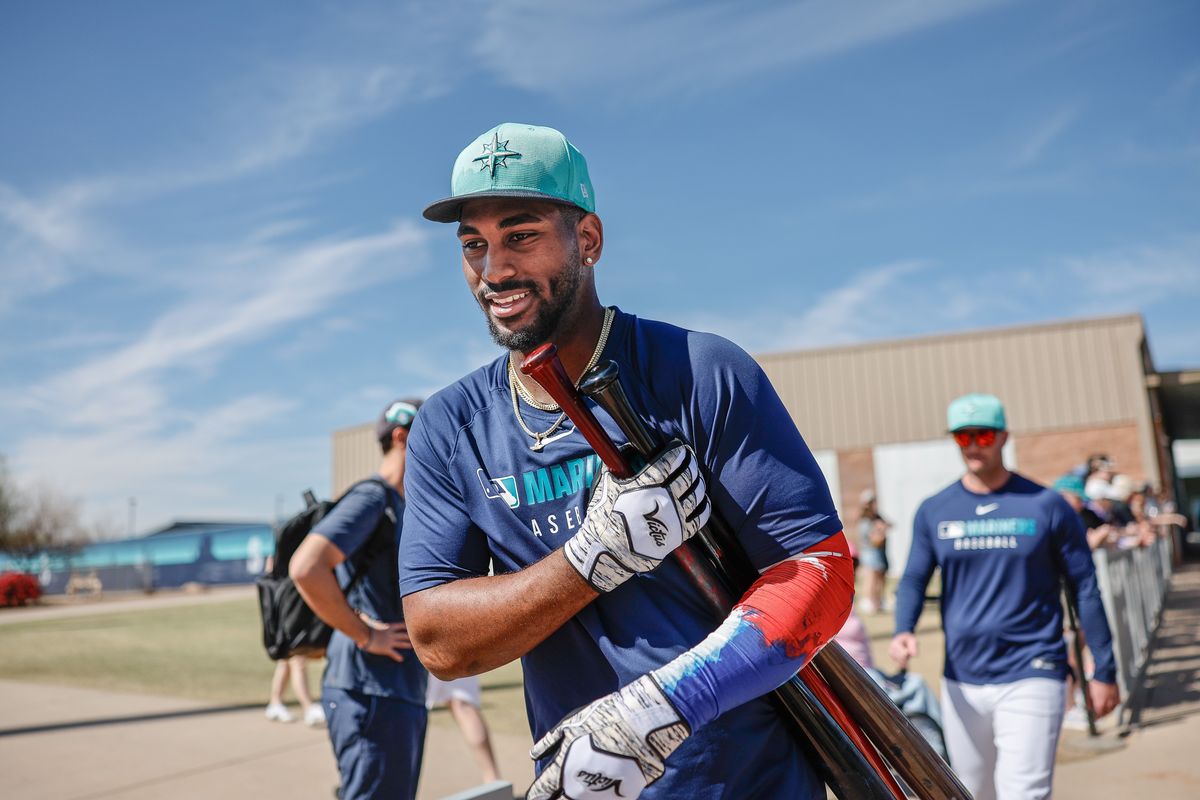 Seattle Mariners outfielder Lazaro Montes passes through the phalanx of fans seeking an autograph Thursday in Peoria, Ariz. (Dean Rutz/Seattle Times)