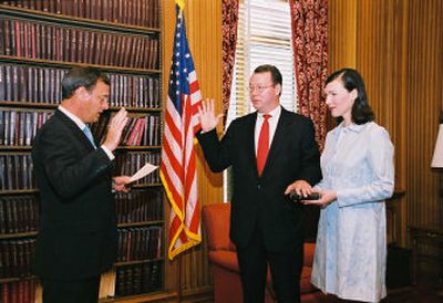 
U.S. Chief Justice John Roberts swears in Freeman High School graduate Phil Moeller as a member of the Federal Energy Regulatory Commission. Holding the Bible  is his wife, Elizabeth Vella Moeller. 
 (Steve Petteway, Collection of the Supreme Court of the United States / The Spokesman-Review)