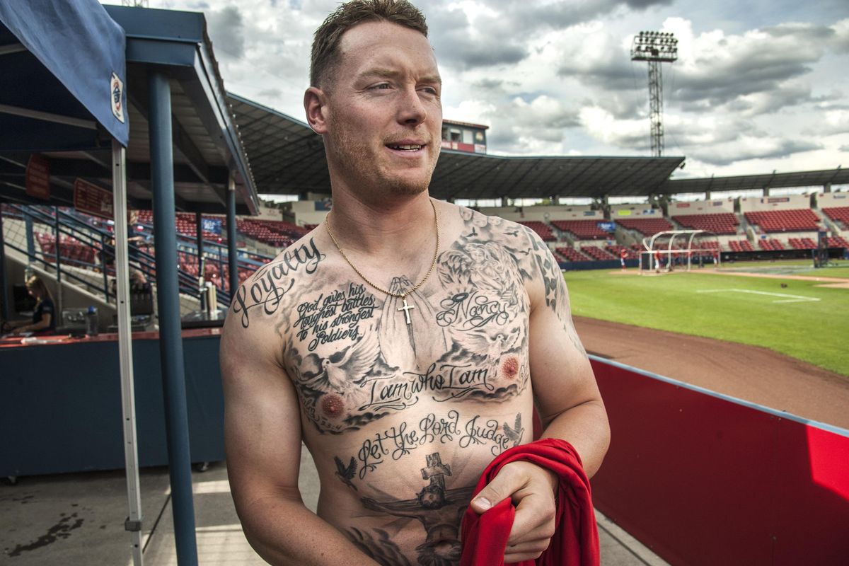 Spokane Indians pitcher Kevin Lenik  has tattoos honoring his mother, sister, brother and religious beliefs. (Dan Pelle / The Spokesman-Review)