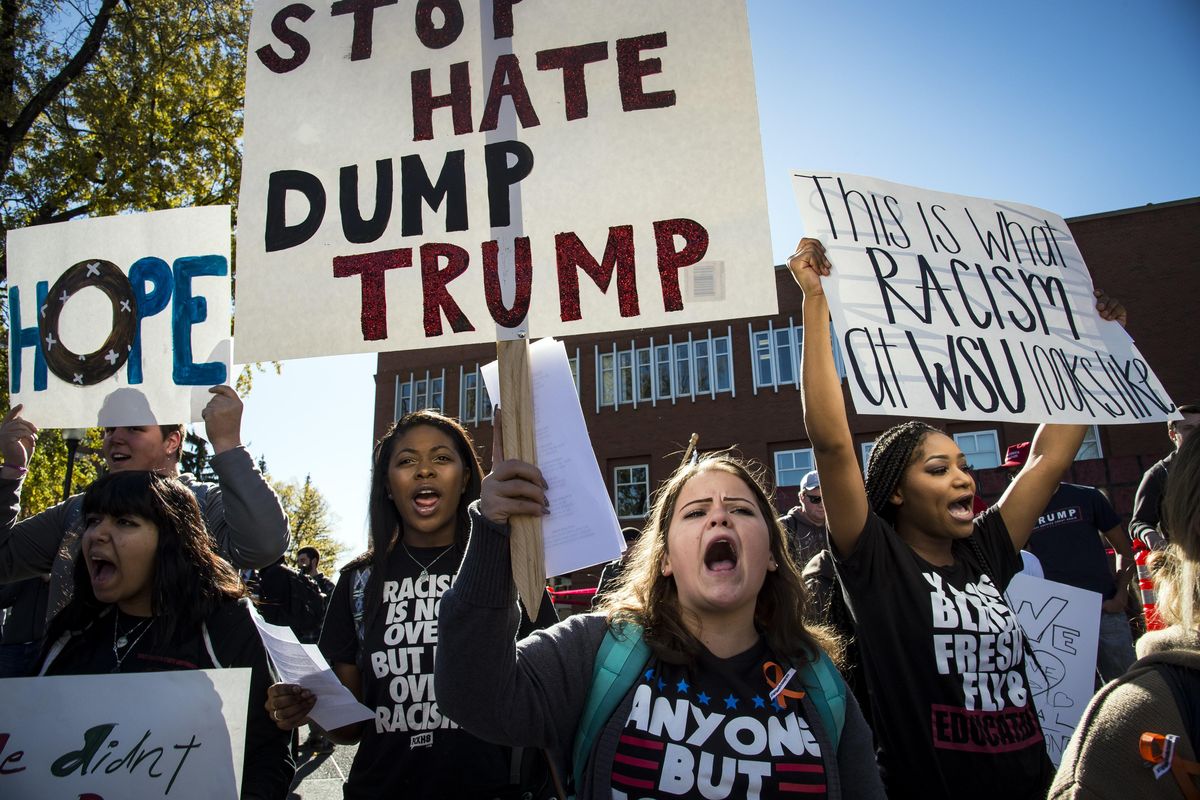WSU student, Tosha Chavez, 21, center, protests the Trump Wall during the WSU College Republicans Trump Wall demonstration and Unity Rally counter protest Wed., on the WSU campus, Oct. 19, 2016, in Pullman, Wash. (Colin Mulvany / The Spokesman-Review)