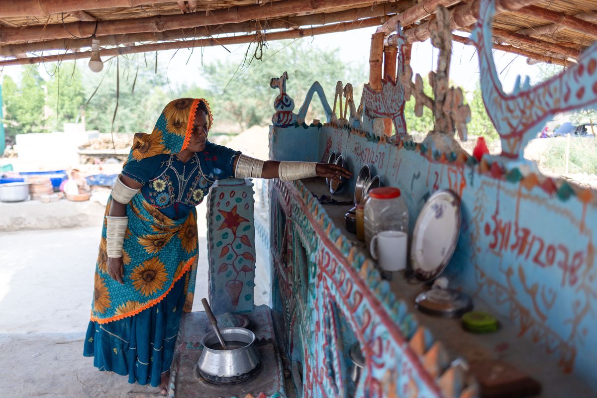 Raheela cooks in an outdoor kitchen, a tenet of the new sustainable bamboo villages. MUST CREDIT: Saiyna Bashir for The Washington Post.  (Saiyna Bashir/For The Washington Post)